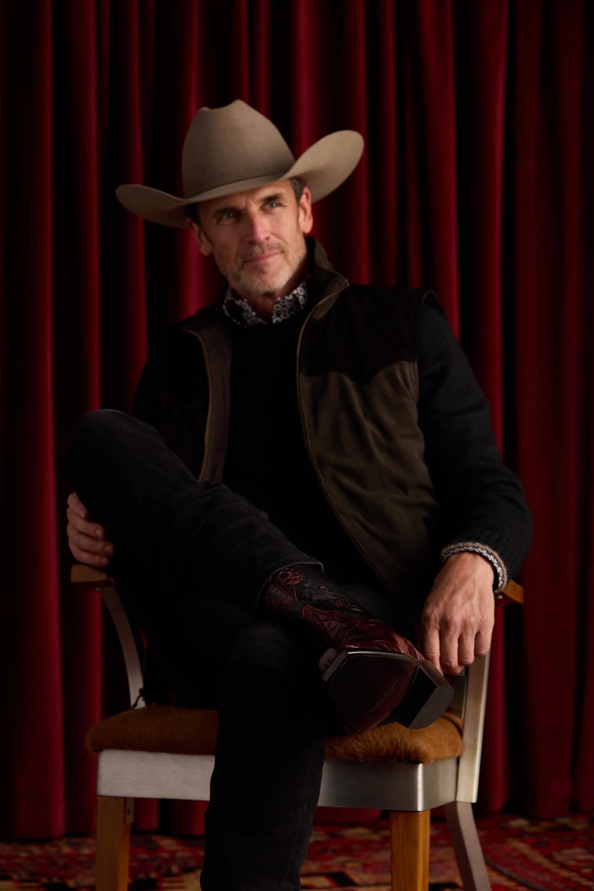 Mission Black Cherry — seated, boot crossed showing alligator vamp + inlay 13